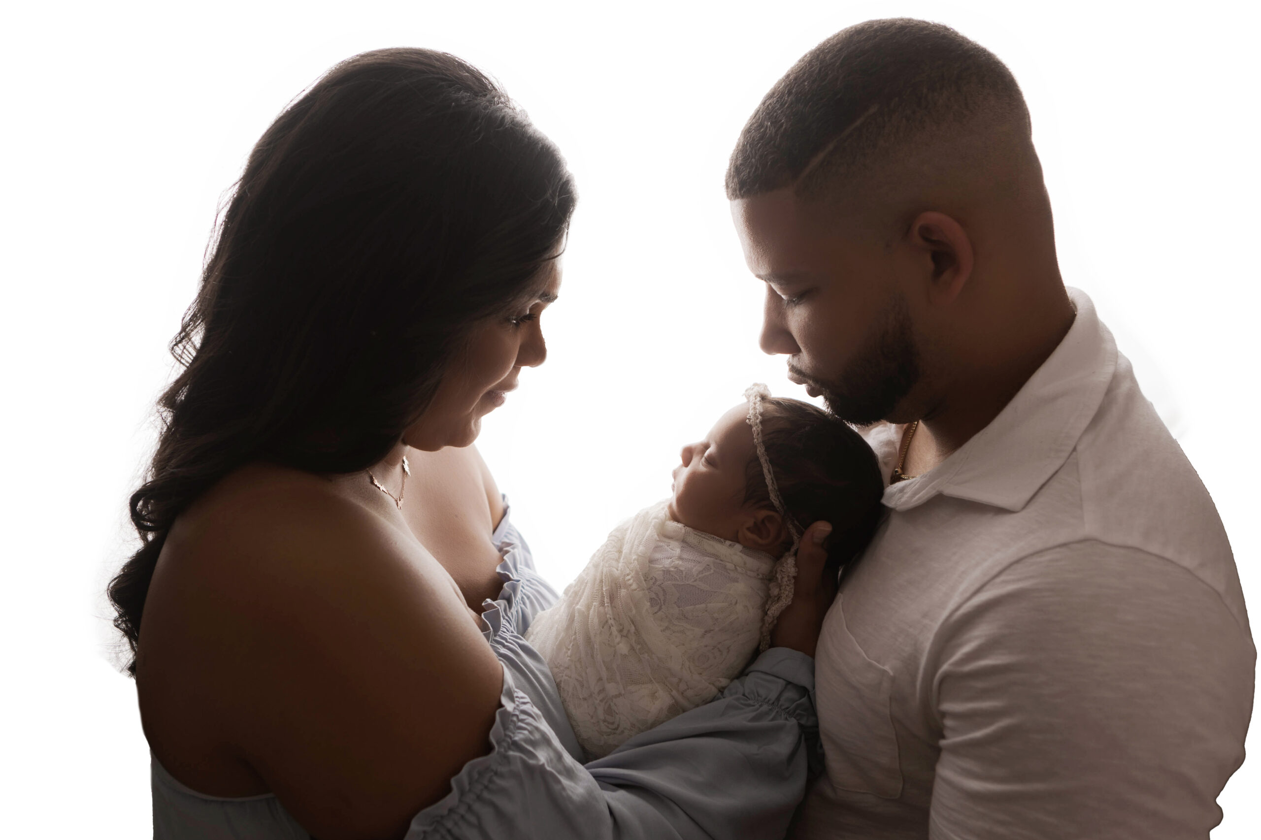 mother, father and baby girl standing in front of a white background during newborn photo session