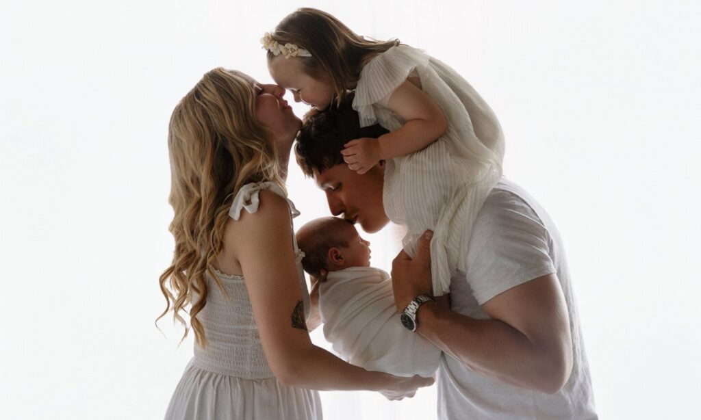 Oklahoma City newborn photography session with a mother holding her newborn baby in natural light