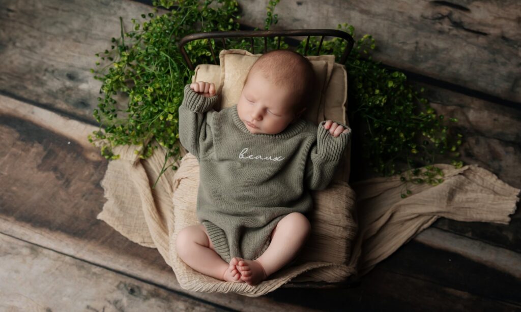 Sleepy newborn posed during a studio session with an Oklahoma City newborn photographer
